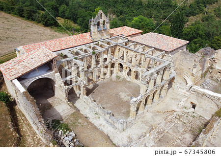 Aerial view of the Ruins Of An Ancient Abandoned Monastery In Santa Maria De Rioseco, Burgos, Spain. 67345806