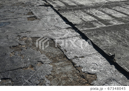 Bitumen flat roofing renovation, background texture of removed damaged insulation layer of roof 67348045