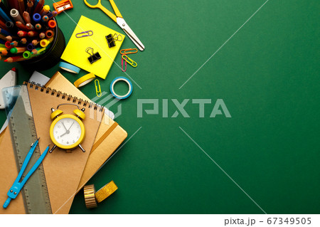 Colorful stationary school supplies on green 67349505