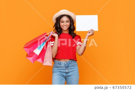 Happy female shopper with blank banner 67350572