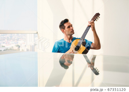 Portrait Of Adult Man Playing Classic Guitar And Singing Portrait Of Adult Man Playing Classic Guitar And Singing 67351120