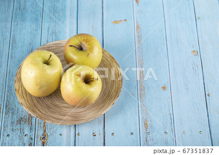 Three green apples in a plate Three green apples in a plate 67351837