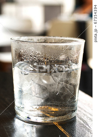 Cold ice water with ice bar in clear glass  67354394
