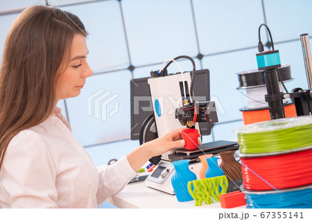 Young female designer working on a prototype 67355141