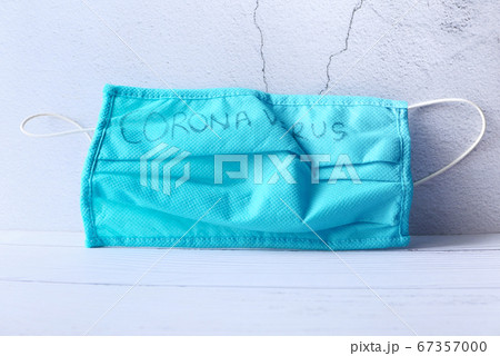 Surgical masks with rubber ear straps drop on gray background Surgical masks with rubber ear straps drop on gray background 67357000