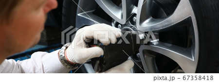 Mechanic using impact wrench Mechanic using impact wrench 67358418
