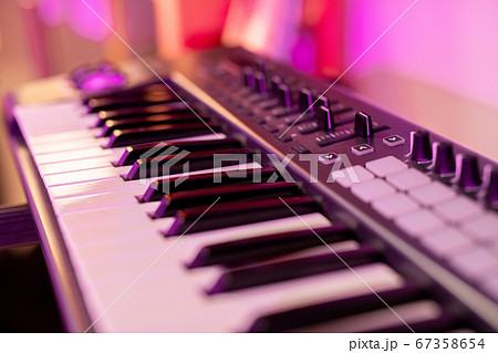 Part of piano keyboard with black and white keys, buttons and many sliders 67358654