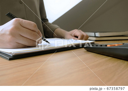 Businessman working with income statement document on the wood table.Business concept. Businessman working with income statement document on the wood table.Business concept. 67358797