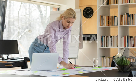 Caucasian businesswoman make notes working with project in office 67359360
