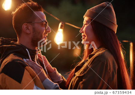 Young affectionate intercultural man and woman looking at one another 67359434