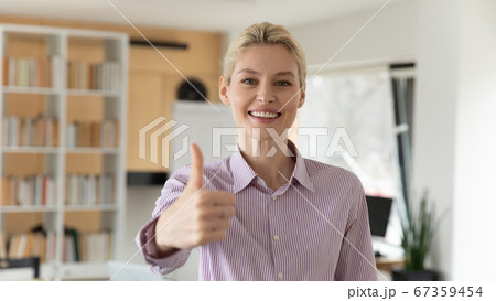 Headshot portrait of smiling businesswoman show thumb up 67359454