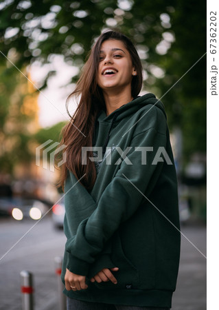 Portrait of cute girl with long hair looks at the camera 67362202