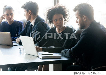 Young diverse business people, working in small groups on projects. 67363888