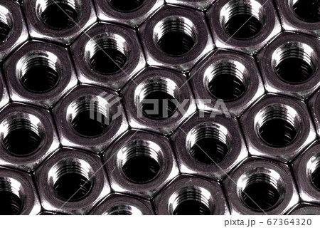 Metal steel nuts laid in composition on a dark 67364320