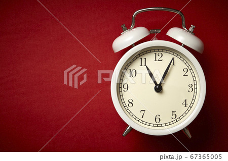 White alarm clock on red background. Close up. Top 67365005