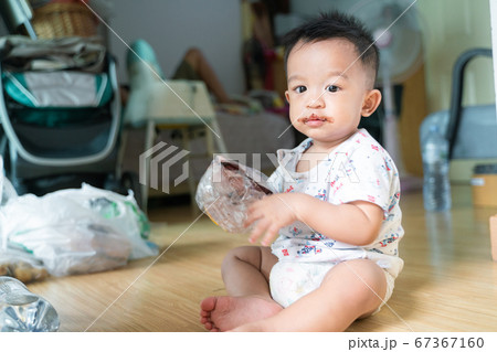 Asian babu boy with chocolate cream dirty on lips 67367160