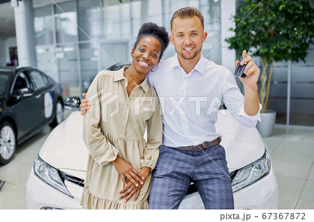 married couple in cars showroom 67367872