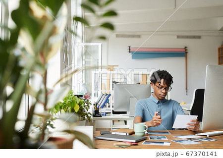 African-American Editor at Desk in Publishing Office 67370141