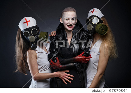 Photo of three women in role play - nurses and evil one 67370344