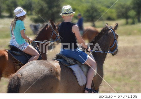 Horse riding tour on a Sunny summer day, two Horse riding tour on a Sunny summer day, two 67371108