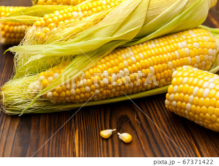 Fresh corn on cobs on rustic wooden table, closeup Fresh corn on cobs on rustic wooden table, closeup 67371422