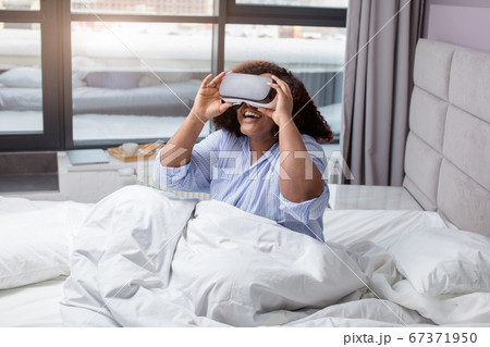 excited ethnic woman using virtual glasses excited ethnic woman using virtual glasses 67371950