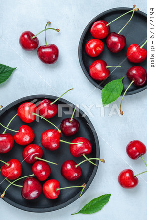 Cherry with leaf on plate and water dropsand on 67372194