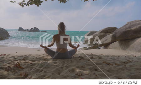Young Woman Practices Yoga 67372542