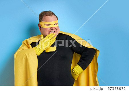 suprised superhero man closing his mouth 67373072