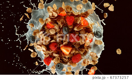 Freeze motion of rotating cereal pieces with milk Freeze motion of rotating cereal pieces with milk 67373257