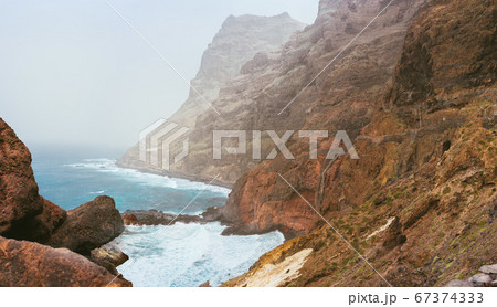 Santo Antao. Cape Verde. Stunning scenery of the coastline. Steep black cliffs stretched out ahead, huge waves crashing against steep rocky shore 67374333