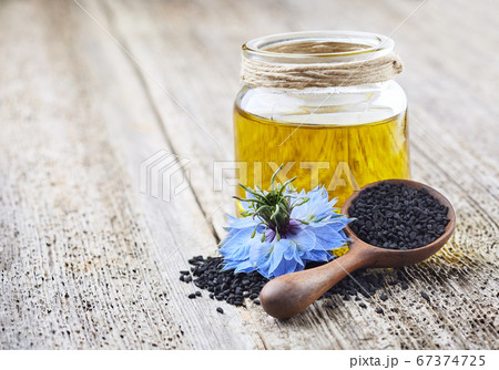 Black cumin oil with flower nigella sativa on 67374725