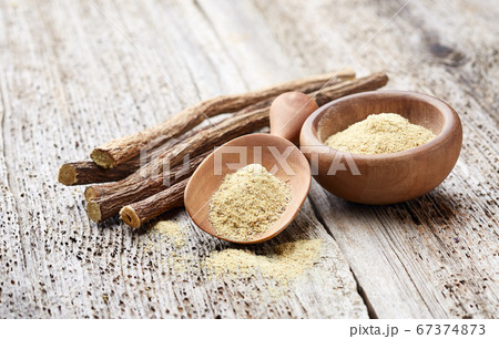 Licorice powder with dry roots on wooden 67374873