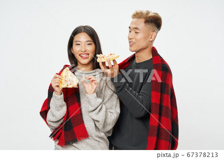 happy young people with slices of pizza and a warm plaid happy young people with slices of pizza and a warm plaid 67378213