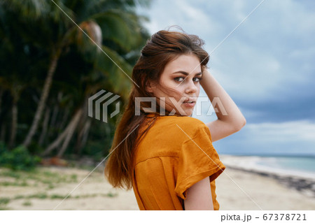 A delightful woman looking at the camera and exotic island A delightful woman looking at the camera and exotic island 67378721