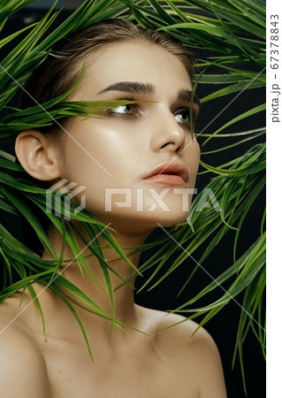 Cropped view woman with green eyes near leaves 67378843