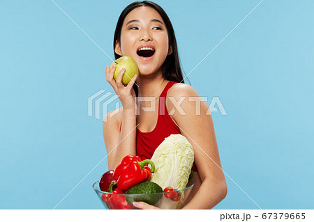 Happy dieting woman with groceries in hand smiling  67379665