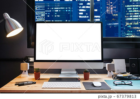 Graphic designer's workspace with city night view Graphic designer's workspace with city night view 67379813