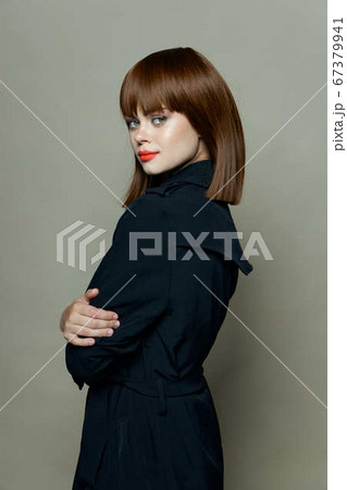 Pretty woman with red lips smiles at the camera  67379941