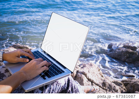 new normal travel and working on the beach 67381087