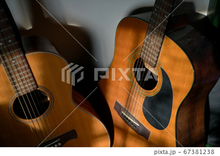 Two classical guitars by the wall 67381238