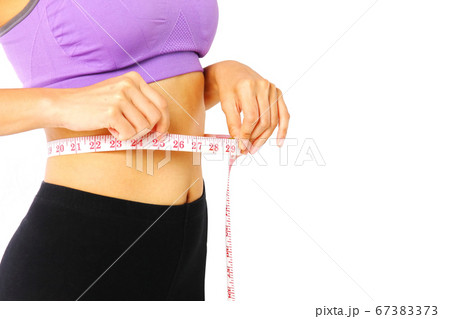 Asian healthy diet woman in sport wear measuring 67383373