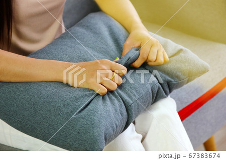 Asian woman patient pinch to gray pillow  between  67383674