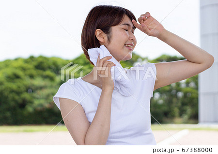 汗を拭く女性の写真素材