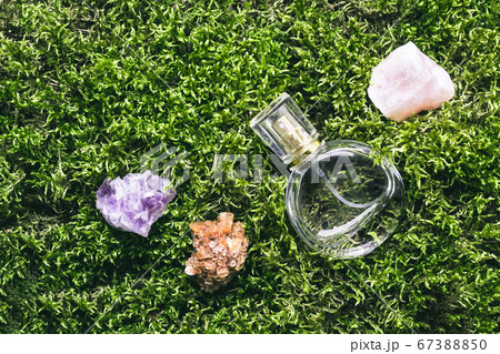 Perfume bottle and minerals stones on beautiful moss background. Nature fragrance beauty concept Perfume bottle and minerals stones on beautiful moss background. Nature fragrance beauty concept 67388850