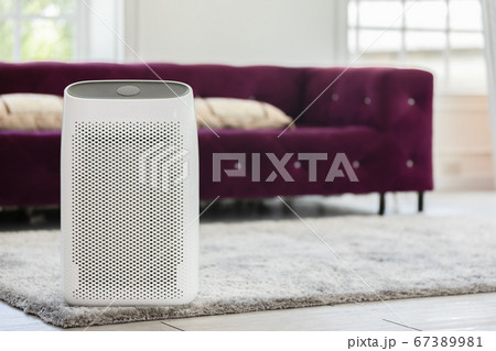 Air purifier in cozy white Living room for filter and cleaning removing dust PM2.5 HEPA in home,for fresh air and healthy life,Air Pollution Concept 67389981