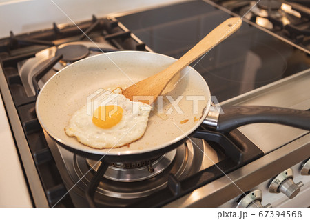 Cooked eggs in a pan in the kitchen Cooked eggs in a pan in the kitchen 67394568