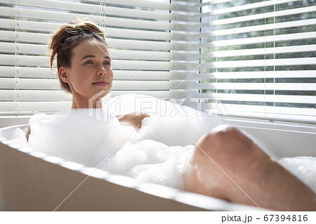 Woman relaxing in a bathtub 67394816