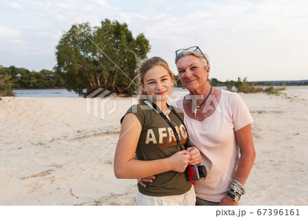 A senior woman and teenage girl, grandmother and her twelve year old grand daughter on vacation. 67396161