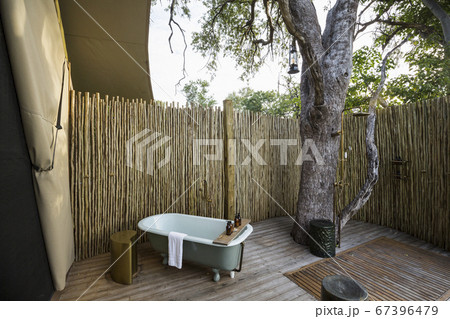 A outdoor bath tub in a tented safari camp 67396479